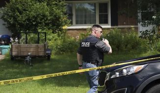 A Lake Hallie Police officer works outside a home Monday, July 29, 2019, in Lake Hallie, Wis., following a shooting the night before. Authorities in northwestern Wisconsin say shootings at two homes have left five people dead, including the suspected shooter, and two others injured. (Renee Jones Schneider/Star Tribune via AP)