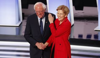 Sen. Bernie Sanders, I-Vt., and Sen. Elizabeth Warren, D-Mass., greet each other before the first of two Democratic presidential primary debates hosted by CNN Tuesday, July 30, 2019, in the Fox Theatre in Detroit. (AP Photo/Paul Sancya)