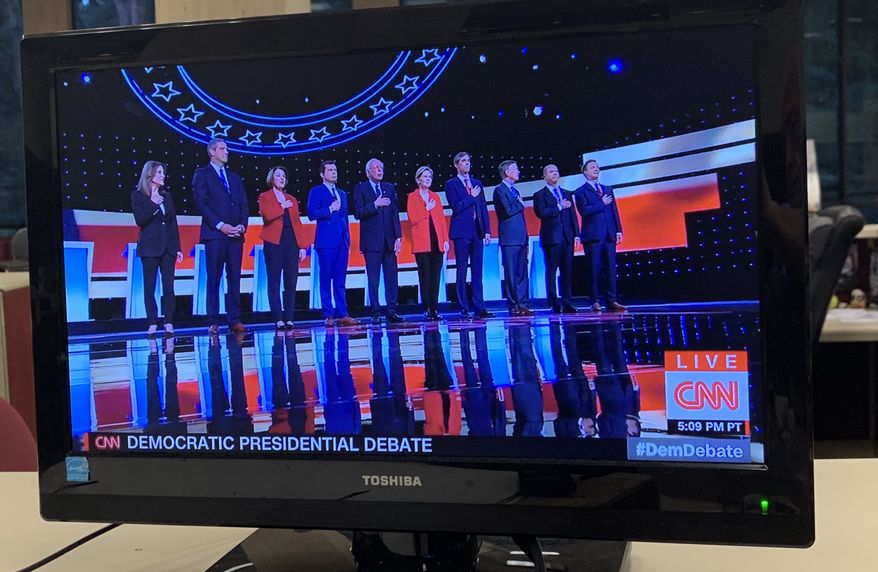 Rep. Tim Ryan of Ohio, second from left, did not put his hand over his heart during the national anthem during Tuesday night's Democratic debate. (Victor Morton/The Washington Times)