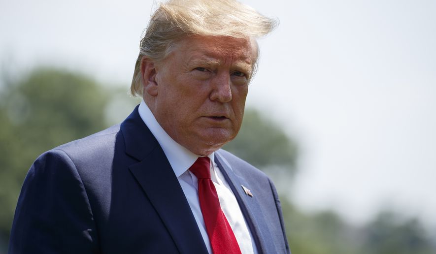 President Donald Trump looks over at the media as he arrives at the White House in Washington, Tuesday, July 30, 2019, as the returns from Virginia. (AP Photo/Carolyn Kaster)