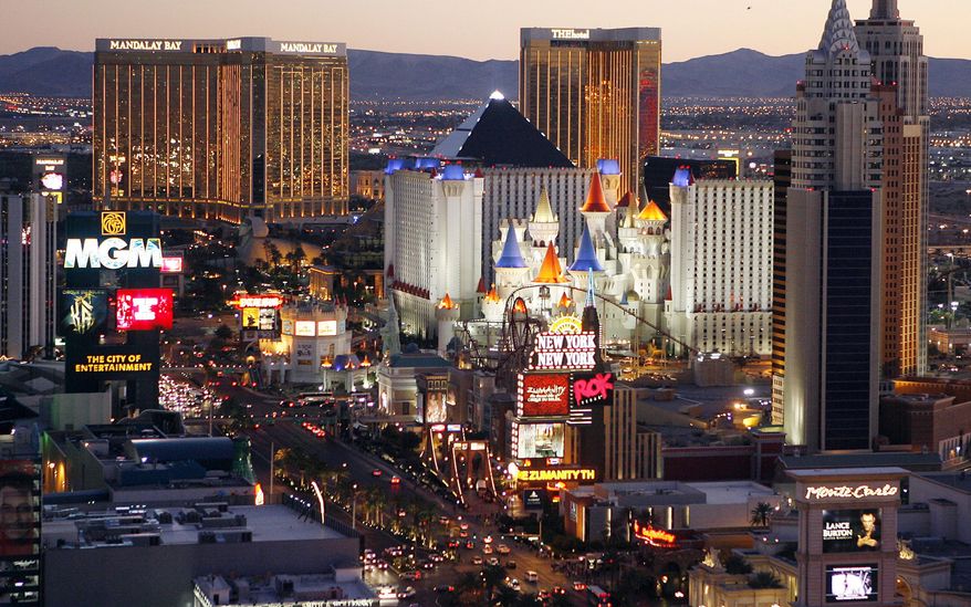 FILE - This Oct. 20, 2009 file photo shows casinos on the Las Vegas Strip. A jump in winnings by casinos in Nevada in June helped push statewide fiscal year gambling figures up a tick, to more than $11.9 billion for the 12 months ending June 30, 2019. (AP Photo/Isaac Brekken, File)
