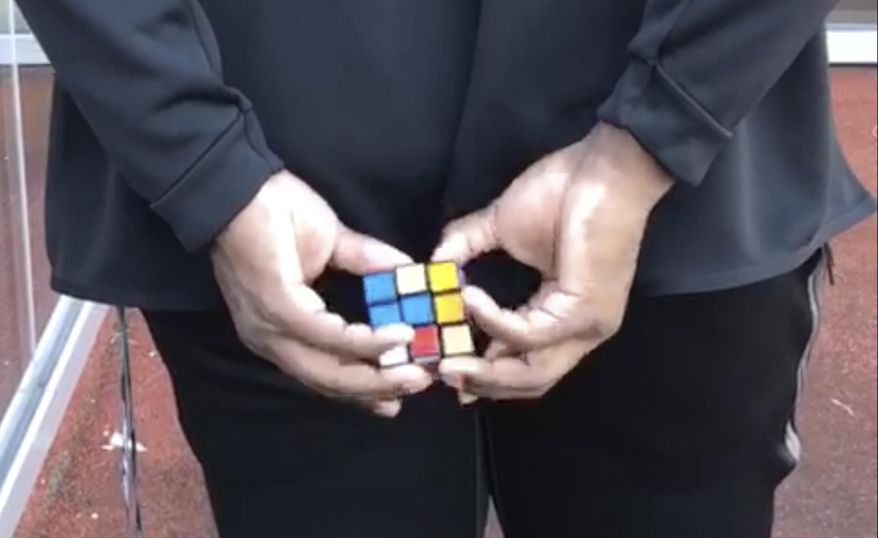 CORRECTS TO BEING CLAIMED OFF WAIVERS FROM THE PATRIOTS, NOT AS AN UNDRAFTED FREE AGENT FROM THE UNIV. OF TEXAS - In this image taken from video, New York Jets rookie offensive lineman Calvin Anderson works on a Rubik's Cube behind his back at the NFL football team's practice facility in Florham Park, N.J., Sunday, July 28, 2019. The puzzle cubes are a bit of an obsession for Anderson, who was claimed off waivers from the Patriots after New England signed him as an undrafted free agent. (AP Photo/Dennis Waszak)