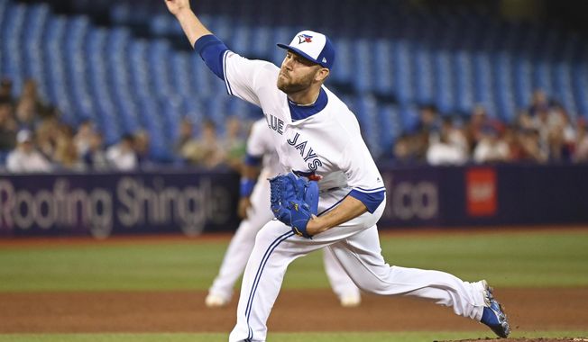 FILE - In this Friday, June 28, 2019 file photo, Toronto Blue Jays&#x27; David Phelps pitches against the Kansas City Royals during the sixth inning of a baseball game in Toronto. The Cubs added bullpen depth by acquiring right-hander David Phelps from Toronto for minor league righty Thomas Hatch, Tuesday, July 30, 2019. (Jon Blacker/The Canadian Press via AP, File)