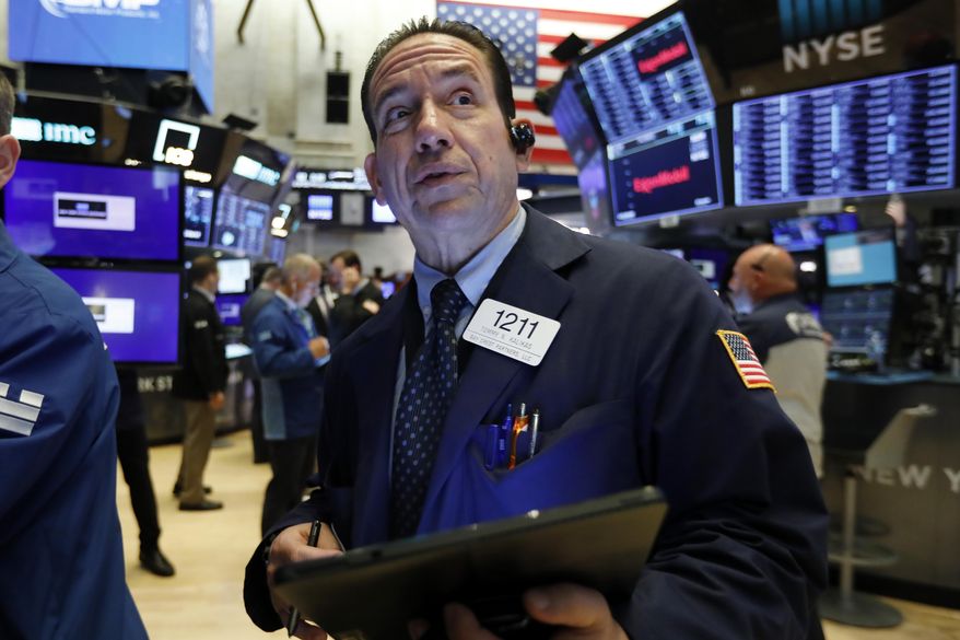 FILE - In this July 22, 2019, file photo trader Tommy Kalikas works on the floor of the New York Stock Exchange. The U.S. stock market opens at 9:30 a.m. EDT on Tuesday, July 30. (AP Photo/Richard Drew, File)
