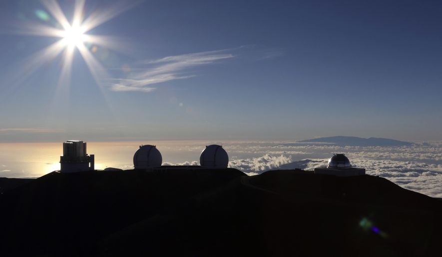 FILE - In this Sunday, July 14, 2019, file photo, the sun sets behind telescopes at the summit of Mauna Kea in Hawaii. The man tasked with trying to find a way out of an impasse over the construction of a giant telescope in Hawaii says he met with Native Hawaiian leaders. But the only issue they reached a consensus on was to meet again. (AP Photo/Caleb Jones, File)