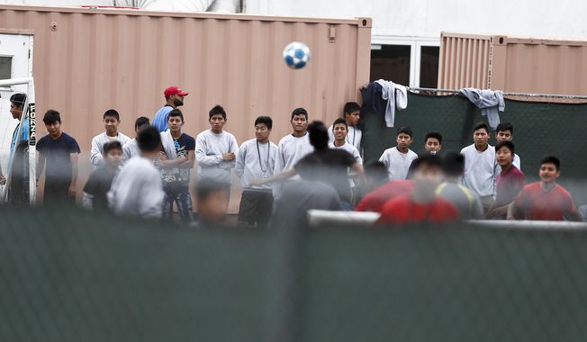 In this Dec. 10, 2018, photo, immigrant boys play soccer at the Homestead Temporary Shelter for Unaccompanied Children, a former Job Corps site that now houses them in Homestead, Fla. The Trump administration is scouting sites in central Florida, Virginia and Los Angeles for future facilities to hold unaccompanied minors who have crossed the U.S.-Mexico border. (AP Photo/Brynn Anderson)