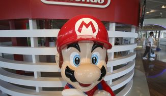 A Super Mario figure is displayed at a showroom in Tokyo, Tuesday, July 30, 2019. Japanese video game maker Nintendo Co. has reported fiscal first quarter profit dipped to about half of what it was the previous year despite improved sales as an unfavorable exchange rate eroded earnings. (AP Photo/Koji Sasahara)