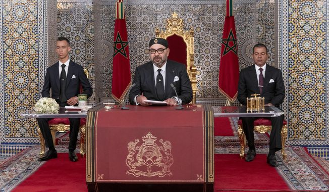 In this photo provided by the Moroccan News Agency (MAP), Morocco&#x27;s King Mohammed VI, center, accompanied by his son Crown Prince Moulay Hassan, left, and brother Prince Moulay Rashid addresses the Nation in a speech aired on TV, at the Royal Palace in Tetouan, Morocco, on Monday July 29, 2019. Morocco鈥檚 king is calling for a government reshuffle, seeking 鈥渘ew blood鈥� and saying the country鈥檚 current development policy isn鈥檛 doing enough to meet Moroccans鈥� needs. In a speech Monday night marking his 20 years on the throne, King Mohammed VI reproached the Islamist-led government and tasked Prime Minister Saad-Eddine El Othmani with proposing new government candidates in the fall. (Moroccan Royal Palace via AP)