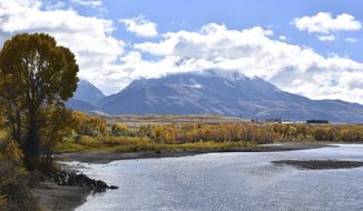 FILE - In this Oct. 8, 2018 file photo, emigrant Peak is seen rising above the Paradise Valley and the Yellowstone River near Emigrant, Mont. The Trump administration has put a conservative advocate who argues for selling off the nation’s public lands in charge of the nation’s 250 million public acres. Interior Secretary David Bernhardt on Monday signed an order making William Perry Pendley acting head of the Bureau of Land Management, putting the lawyer and Wyoming native in charge of public lands and their resources.  (AP Photo/Matthew Brown)