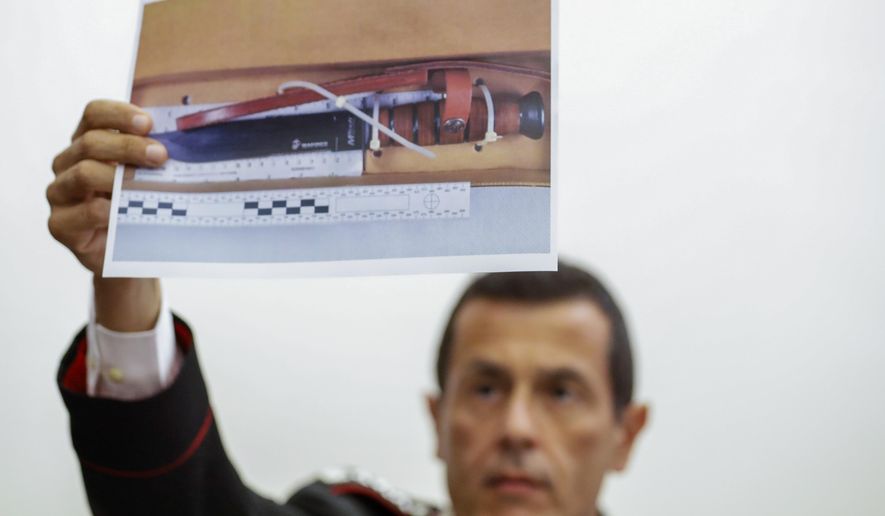 Carabinieri Colonel Lorenzo D'Aloia shows a picture of the knife used to stab Carabinieri's officer Mario Cerciello Rega, during a press conference in Rome, Tuesday, July 30, 2019. Two American teenagers were jailed in Rome on Saturday as authorities investigate their alleged roles in the fatal stabbing of the Italian police officer on a street near their hotel. (AP Photo/Andrew Medichini)