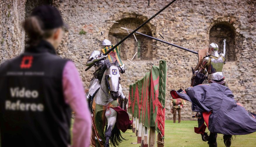 In this photo issued by English Heritage Wednesday July 31, 2019, Medieval jousting is being brought up-to-date with tests to use VAR Hawk-Eye video review technology to make sure scoring is accurate, with English Heritage testing the new tech, in Framlington, England, ahead of the upcoming 2019 season of jousting competitions. English Heritage says accuracy is vital in jousting, a sport in which participants on horseback charge at speeds of up to 30 miles per hour (48 kph) to strike their opponent, and now VAR may make scoring accurate. (Jim Holden/English Heritage via AP)