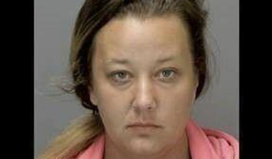 FILE--In this undated booking file photo released by the Ingham County Jail shows Sarah Conde. Conde, 29, is one of two Michigan parents accused of child abuse has been sentenced to 3-10 years in prison. The Lansing State Journal reports Conde learned her punishment Wednesday, July 31, 2019 after earlier pleading guilty to child abuse. She apologized, saying: "I do acknowledge that I did fail as a parent." The abuse was discovered in 2017 in Lansing.(Ingham County Jail via AP, File)