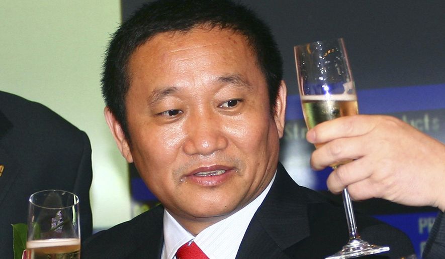 FILE - In this May 8, 2009 file photo, Liu Zhongtian, the Chinese billionaire chairman of the China Zhongwang Holdings Limited, celebrates at the company's listing ceremony in the Hong Kong Stock Exchange. Liu has been charged in Los Angeles in a complex scheme to avoid $1.8 billion in aluminum tariffs, U.S. prosecutors said, Wednesday, July 31, 2019. Liu and the aluminum company he previously headed, were charged with conspiracy, wire fraud and money laundering. (AP Photo/File)