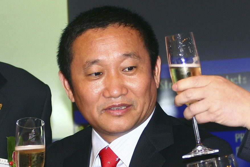 FILE - In this May 8, 2009 file photo, Liu Zhongtian, the Chinese billionaire chairman of the China Zhongwang Holdings Limited, celebrates at the company's listing ceremony in the Hong Kong Stock Exchange. Liu has been charged in Los Angeles in a complex scheme to avoid $1.8 billion in aluminum tariffs, U.S. prosecutors said, Wednesday, July 31, 2019. Liu and the aluminum company he previously headed, were charged with conspiracy, wire fraud and money laundering. (AP Photo/File)