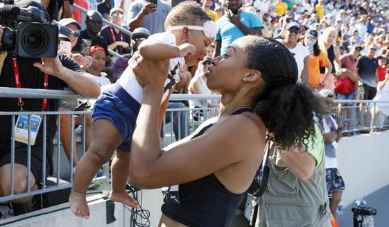 FILE - In this July 27, 2019, file photo, Allyson Felix holds her daughter Camryn after running the women&#39;s 400-meter dash final at the U.S. Championships athletics meet in Des Moines, Iowa. These days, sprinter Allyson Felix is racing for more than just medals. The six-time Olympic gold medalist is campaigning for the rights of mothers after giving birth in November. (AP Photo/Charlie Neibergall, File)