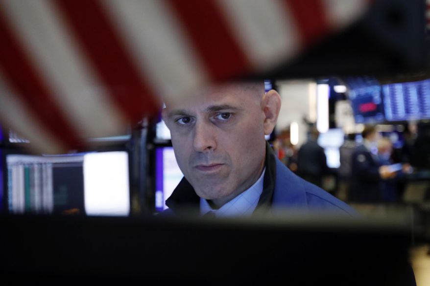 FILE - In this July 22, 2019, file photo specialist Mark Fitzgerald works at his post on the floor of the New York Stock Exchange. The U.S. stock market opens at 9:30 a.m. EDT on Wednesday, July 31. (AP Photo/Richard Drew, File)