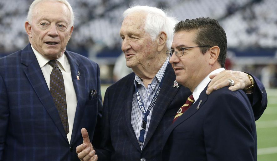 FILE - In this Nov. 24, 2016, file photo, Dallas Cowboys team owner, Jerry Jones, left, Gil Brandt of NFL.Com, center,  and Washington Redskins team owner Daniel Snyder pose for a photo on the field during team warm ups before an NFL football game in Arlington, Texas. Brandt will be inducted into the Pro Football Hall of Fame in Canton, Ohio on Aug. 3, 2019. (AP Photo/Michael Ainsworth, File)