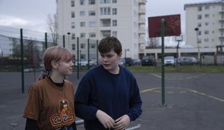 This photo taken Monday, May 13, 2019, shows Karen Guttensen and Ingvar Ingolfsson, right, both 14-years old, outside the Tjornin youth center in Reykjavik, Iceland, on a bright summer night.  The island nation in the North Atlantic has dried up a teenage culture of drinking and smoking by  focusing on local participation in music and sports options for students, with such success that Icelandic teens now have one of the lowest rates of substance abuse in Europe. (AP Photo/Egill Bjarnason)