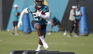 Jacksonville Jaguars running back Leonard Fournette runs through a drill during an NFL football practice at the teams training facility, Friday, July 26, 2019, in Jacksonville, Fla. (AP Photo/John Raoux)