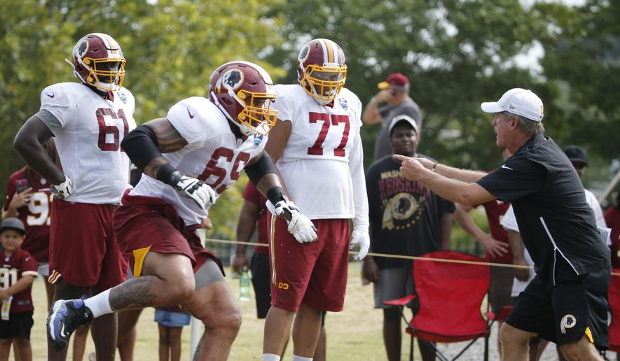 Washington Redskins offensive lineman, Hugh Thornton (69) runs drills as he is directed by offensive line coach Bill Callahan, right, during NFL football training camp in Richmond, Va., Wednesday, July 31, 2019. Thornton was signed Wednesday. (AP Photo/Steve Helber) **FILE**