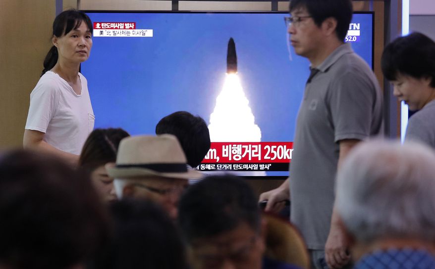 People watch a TV showing a file image of North Korea's missile launch during a news program at the Seoul Railway Station in Seoul, South Korea, Wednesday, July 31, 2019. North Korea fired two short-range ballistic missiles off its east coast Wednesday, South Korea’s military said, its second weapons test in less than a week. (AP Photo/Ahn Young-joon)