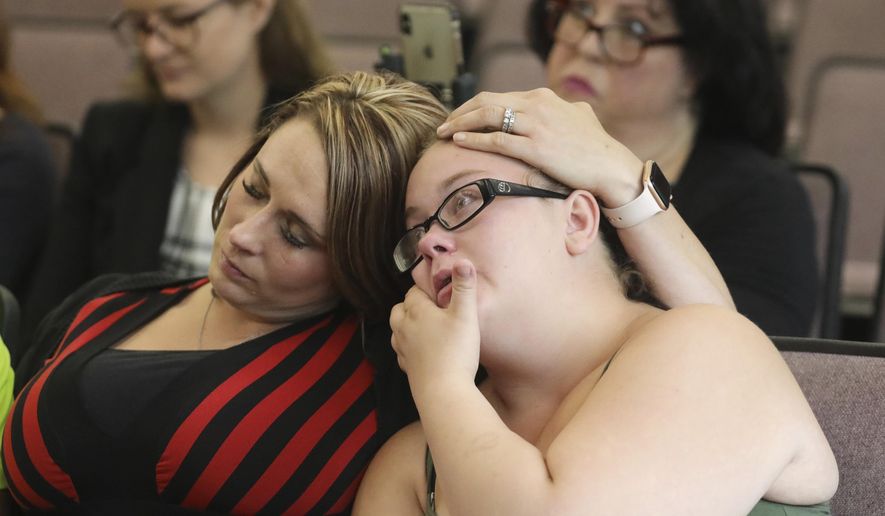 Amanda Hunt, left, aunt of Brelynne "Breezy" Otteson, and Nikka Powell, Riley Powell's sister listen during a news conference Wednesday, July 31, 2019, in Provo, Utah. Prosecutors say they will seek the death penalty for a Utah man accused of killing two teenagers and dumping their bodies in an abandoned mine shaft. Jerrod Baum has pleaded not guilty to charges of aggravated murder in the deaths of 17-year-old Brelynne "Breezy" Otteson and 18-year-old Riley Powell. The teens were reported missing in December 2017. Their bodies were found in a mine near Eureka three months later. (AP Photo/Rick Bowmer)