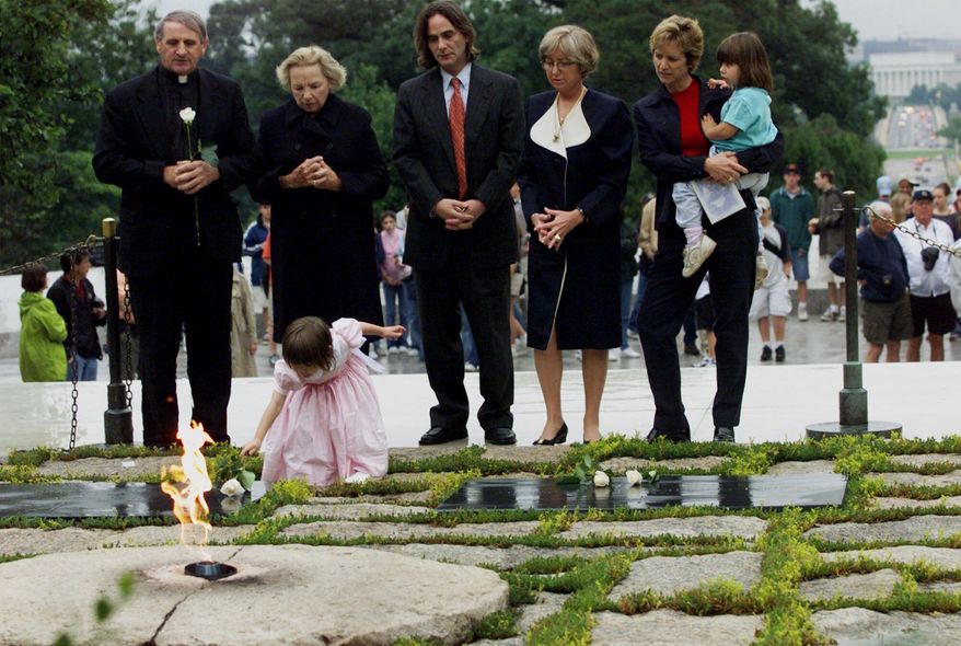 FILE - In this June 6, 2000 file photo, Robert F. Kennedy's granddaughter Saoirse Kennedy Hill places a white rose at the Eternal Flame, President John F. Kennedy's gravesite, at Arlington National Cemetery in Arlington, Va. Hill, has died at the age of 22. The Kennedy family released a statement on Thursday night, Aug. 1, 2019, following reports of a death at the family's compound in Hyannis Port, Massachusetts. Hill was the daughter of Robert and Ethel Kennedy's fifth child, Courtney, and Paul Michael Hill. (AP Photo/Hillery Smith Garrison, File)