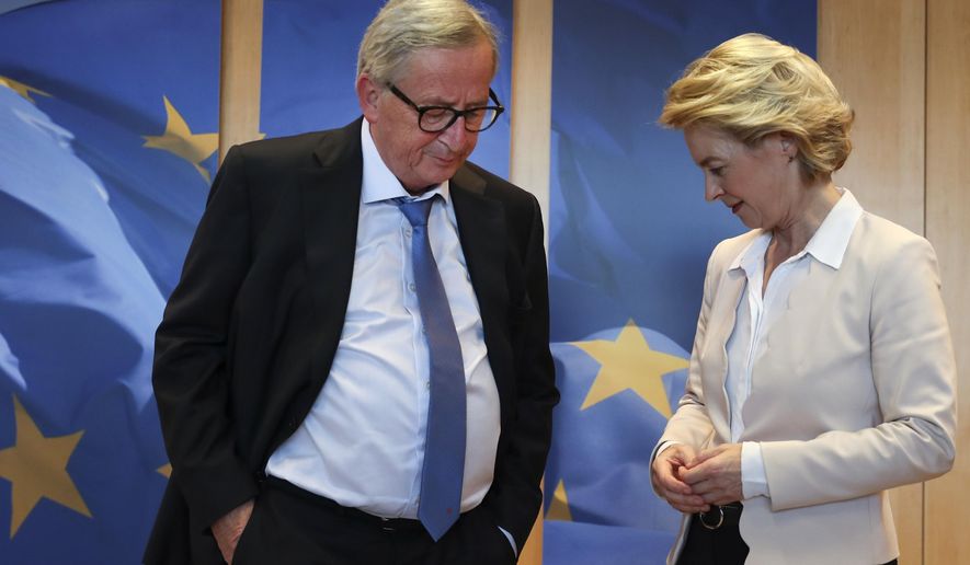 European Commission President Jean-Claude Juncker, left, welcomes newly designated European Commission President Ursula von der Leyen prior to a meeting at EU headquarters in Brussels, Tuesday, July 23, 2019. (AP Photo/Francisco Seco)