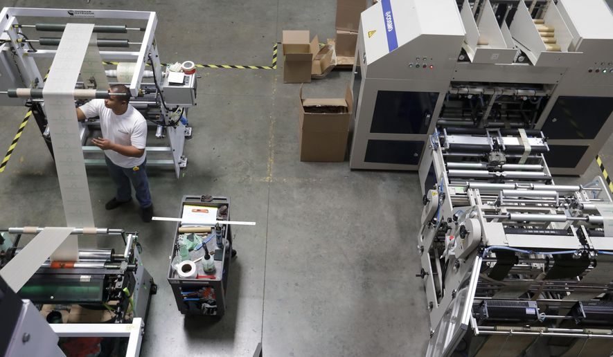 In this July 5, 2019, file photo Andre Harris works on the line at beyond Green, a maker of biodegradable bags in Lake Forest, Calif. U.S. factory activity expanded at a slower rate in July, as measures of production and employment fell. The Institute for Supply Management, an association of purchasing managers, says that its manufacturing index slipped to 51.2 last month from 51.7 in June. (AP Photo/Chris Carlson)