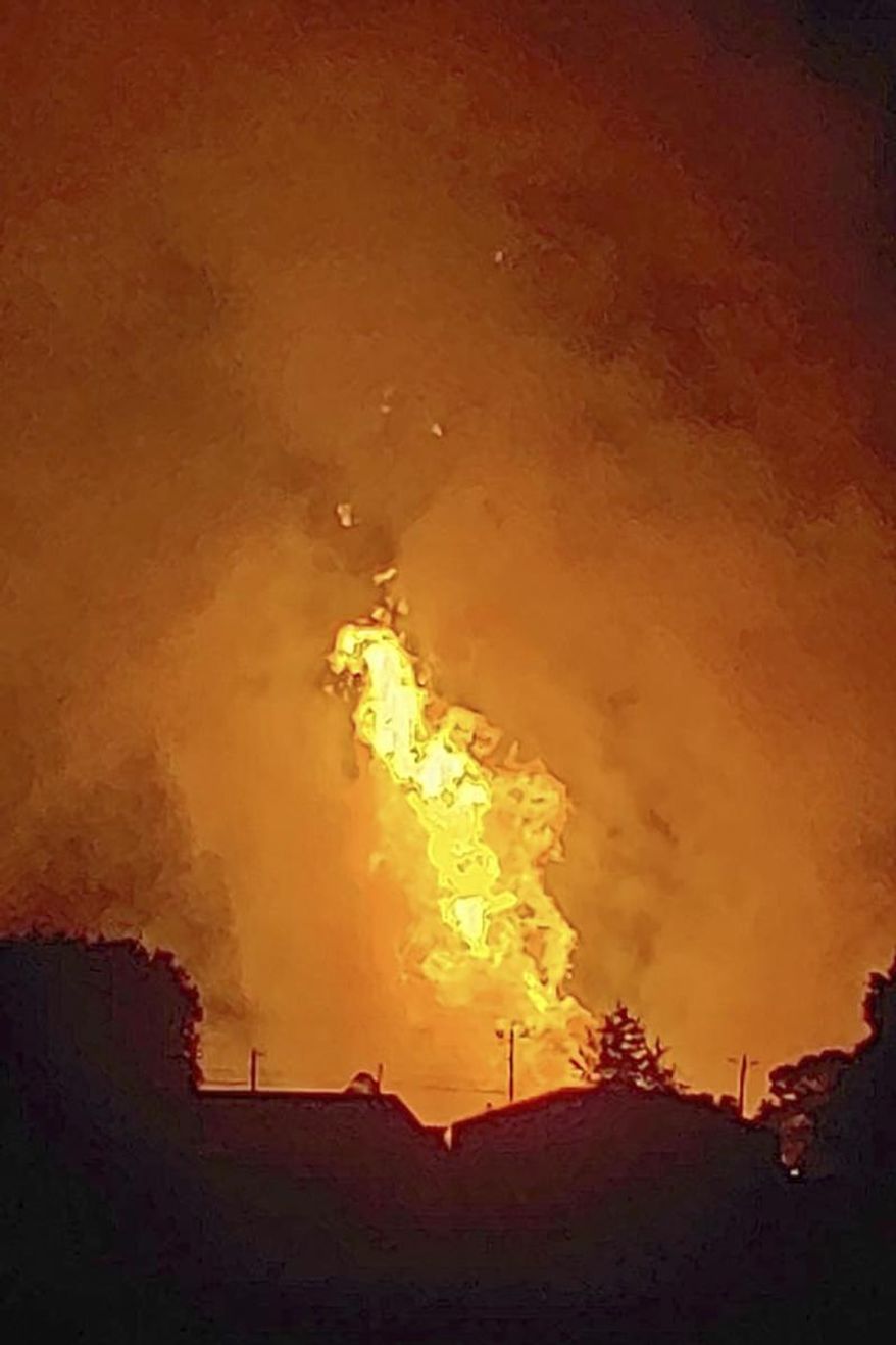 In this Thursday, Aug. 1, 2019, photo provided by Naomi Hayes, a fire burns after an explosion near Junction City, Ky. A regional gas pipeline ruptured early Thursday in Kentucky, causing a massive explosion that killed one person, hospitalized five others, destroyed railroad tracks and forced the evacuation of a nearby mobile home park, authorities said. (Naomi Hayes via AP)