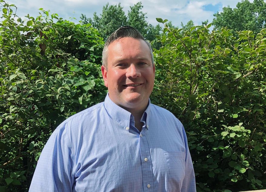 In this Tuesday, July 30, 2019, photo, Democrat Josh Hicks poses for a photo in Frankfort, Ky. Hicks has launched his campaign for the congressional seat in Kentucky’s 6th District. Hicks is a Marine veteran and former police officer who hopes to unseat Republican U.S. Rep. Andy Barr in the district. (AP Photo/Bruce Schreiner)