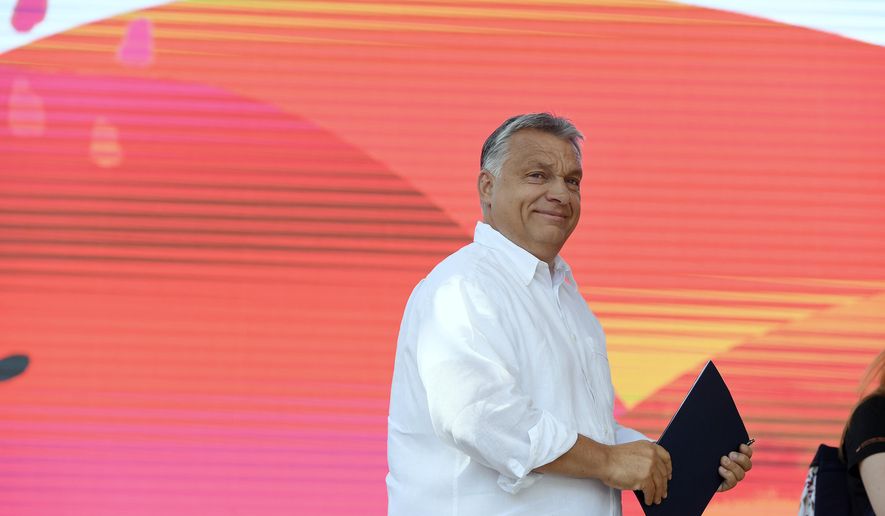 Hungarian Prime Minister Viktor Orban arrives on the stage to speak at the 30th Balvanyos Summer University and Students' Camp in Baile Tusnad, Transylvania, Romania, Saturday, July 27, 2019. (Szilard Koszticsak/MTI via AP)