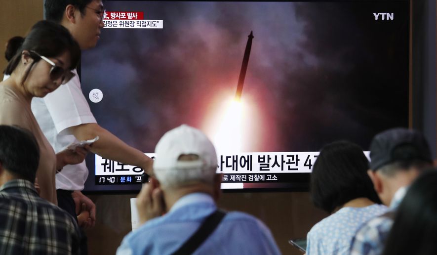 People watch a TV showing an image of North Korea's a multiple rocket launch during a news program at the Seoul Railway Station in Seoul, South Korea, Thursday, Aug. 1, 2019. North Korea said Thursday leader Kim Jong Un supervised the first test firing of a new multiple rocket launcher system that could potentially enhance its ability to strike targets in South Korea and U.S. military bases there.(AP Photo/Ahn Young-joon)