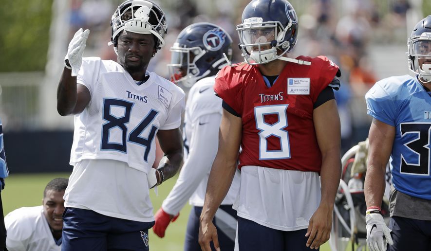 Tennessee Titans wide receiver Corey Davis (84) talks with quarterback Marcus Mariota (8) during NFL football training camp Wednesday, July 31, 2019, in Nashville, Tenn. (AP Photo/Mark Humphrey)
