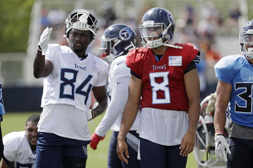 Tennessee Titans wide receiver Corey Davis (84) talks with quarterback Marcus Mariota (8) during NFL football training camp Wednesday, July 31, 2019, in Nashville, Tenn. (AP Photo/Mark Humphrey)