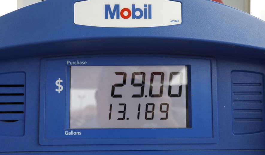 FILE - In this June 26, 2019, file photo a Mobil gas pump displays the various types of fuel and their prices at this Flowood, Miss., station. Exxon Mobil Corp. reports financial results Friday, Aug. 2. (AP Photo/Rogelio V. Solis, File)