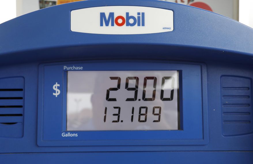 FILE - In this June 26, 2019, file photo a Mobil gas pump displays the various types of fuel and their prices at this Flowood, Miss., station. Exxon Mobil Corp. reports financial results Friday, Aug. 2. (AP Photo/Rogelio V. Solis, File)
