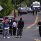Portland police respond to a fatal shooting in Northeast Portland, Ore., on Friday, Aug. 2, 2019. The Portland Police Bureau says officers responding to a shooting report just after 2 p.m. Friday found multiple victims injured. (Beth Nakamura/The Oregonian via AP)