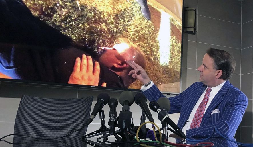 Attorney Geoff Henley points out details in body camera footage from 32-year-old Tony Timpa's 2016 death in the custody of Dallas police officers during a press conference, Friday, Aug. 2, 2019 in Dallas. Two Dallas police officers involved in the arrest of a 911 caller who died in their custody told commanders they mocked the handcuffed man as part of a "strategy" to get him to respond. (AP Photo/Jake Bleiberg)