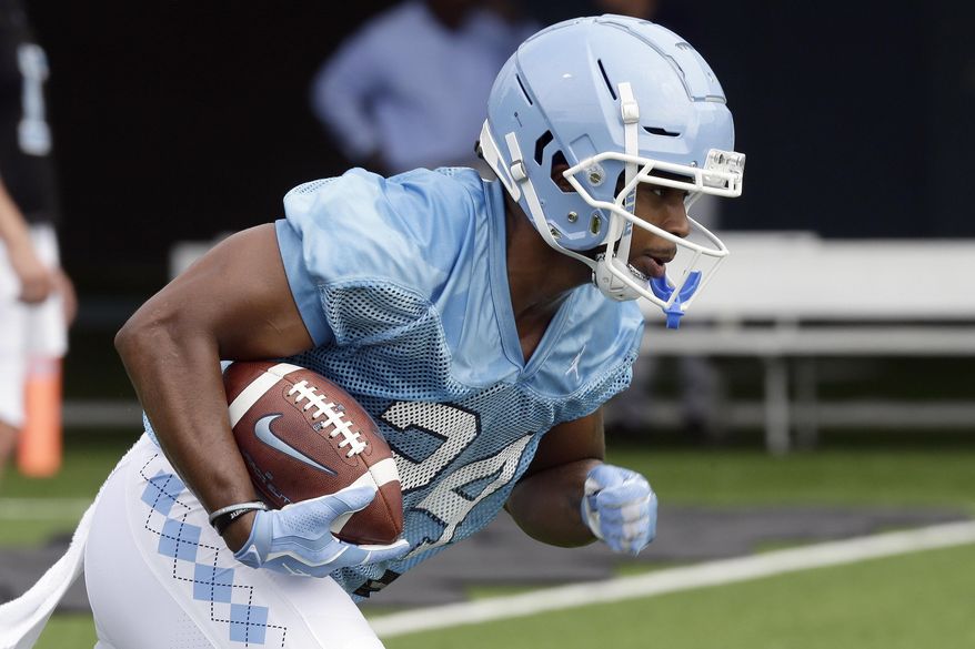 North Carolina running back Antonio Williams (24) runs the ball during NCAA college football practice Friday, Aug. 2, 2019 in Chapel Hill, N.C. (AP Photo/Gerry Broome)