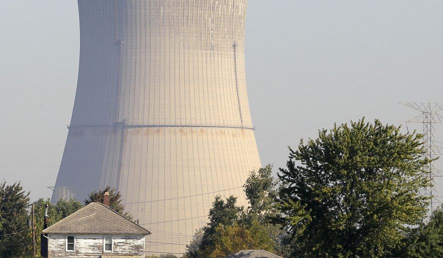 FILE - This Oct. 5, 2011 file photo shows the cooling tower of the Davis-Besse Nuclear Power Station in Oak Harbor, Ohio. A financial rescue for Ohio's nuclear plants and two coal-fired plants has infuriated environmentalists and conservatives. The plan signed into law it July 23, 2019 by Republican Gov. Mike DeWine calls for giving the state’s two nuclear plants $150 million a year through 2026. (AP Photo/Amy Sancetta, File)