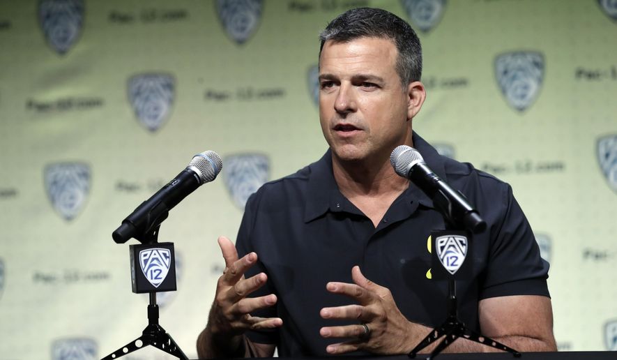 File-This July 24, 2019, file photo shows Oregon head coach Mario Cristobal answering questions during the Pac-12 Conference NCAA college football Media Day in Los Angeles. Cristobal figures the Ducks will have 19 days of traditional fall camp before they start preparing for Auburn.Oregon’s opener, a rematch of sorts of the 2011 national championship game, is set for Aug. 31 at AT&T Stadium in Arlington, Texas.(AP Photo/Marcio Jose Sanchez, File)