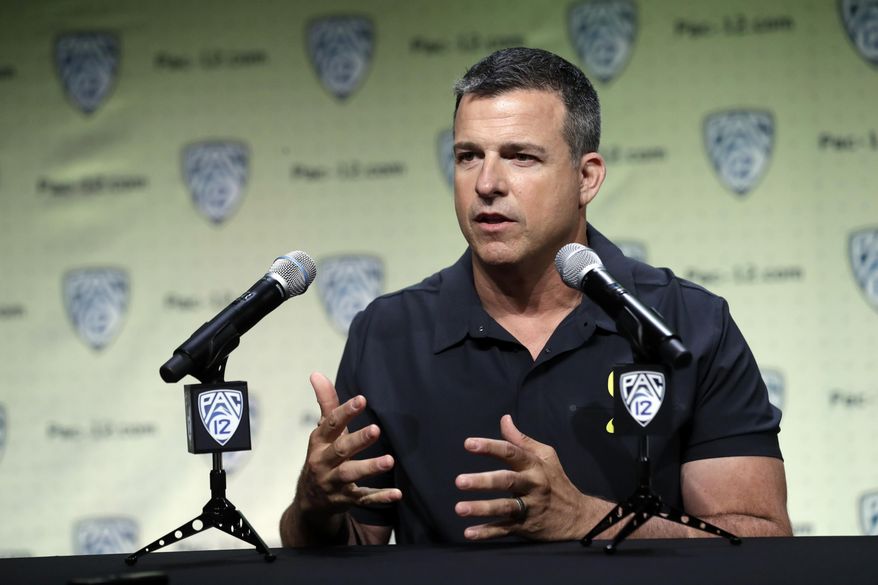 File-This July 24, 2019, file photo shows Oregon head coach Mario Cristobal answering questions during the Pac-12 Conference NCAA college football Media Day in Los Angeles. Cristobal figures the Ducks will have 19 days of traditional fall camp before they start preparing for Auburn.Oregon’s opener, a rematch of sorts of the 2011 national championship game, is set for Aug. 31 at AT&T Stadium in Arlington, Texas.(AP Photo/Marcio Jose Sanchez, File)