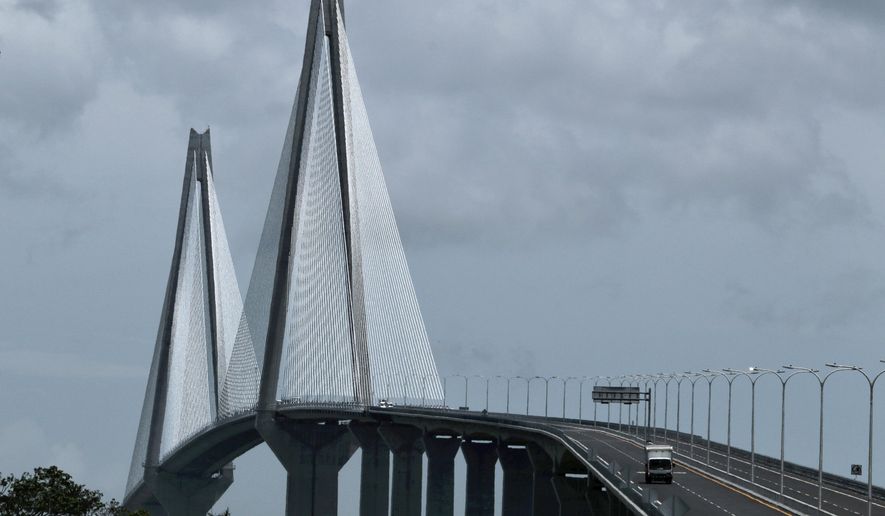 Vehicles drive over the new bridge that spans the Panama Canal, in Colon, Panama, Friday, August 2, 2019. The 4.6 km bridge spans the canal but on the Caribbean side of the country. (AP Photo/Eric Batista)