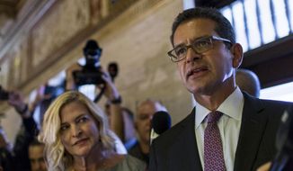 Pedro Pierluisi, who has been nominated Puerto Rico&#39;s Secretary of State, arrives to the Senate with his sister Caridad Pierluisi, his spokesperson, in San Juan, Puerto Rico, Thursday, Aug. 1, 2019. Puerto Rican politics were in full-blown crisis as confirmation of Pierluisi, the nominee to succeed departing Gov. Ricardo Rossello, was delayed into next week, casting doubt over who will become governor when Rossello leaves office. (AP Photo/Dennis M. Rivera Pichardo)