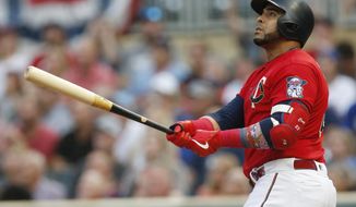 Minnesota Twins&#39; Nelson Cruz watches his two-run home run off Kansas City Royals pitcher Glenn Sparkman during the first inning of a baseball game Friday, Aug. 2, 2019, in Minneapolis. (AP Photo/Jim Mone)