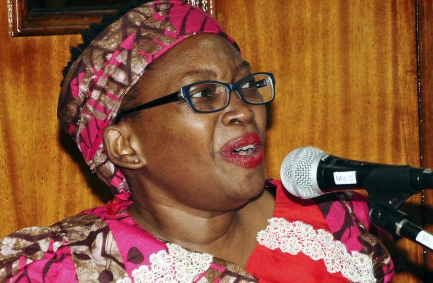 In this photo taken on Thursday, Aug. 1, 2019, former Makerere University researcher Dr. Stella Nyanzi speaks in court in Kampala, Uganda. A Ugandan academic who once called the president "a pair of buttocks" has been sentenced to 18 months in prison after being found guilty of cyber harassment. Stella Nyanzi flashed her bare breasts in protest while appearing in court via video link from prison. Amnesty International has called her conviction "outrageous." (AP Photo/Ronald Kabuubi)