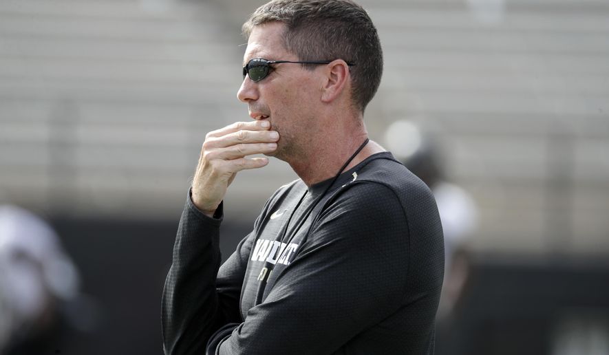 FILE - In this Aug. 16, 2018, file photo, then-Vanderbilt offensive coordinator Andy Ludwig watches during an NCAA college football practice in Nashville, Tenn. Ludwig is back as offensive coordinator at Utah with an evolving playbook. Utah's players are embracing Ludwig's offense with enthusiasm. It is a bit slower and features more huddles between plays than what they've run in the past. Still, they are seeing and absorbing aspects of the game in a whole new way.(AP Photo/Mark Humphrey, File)