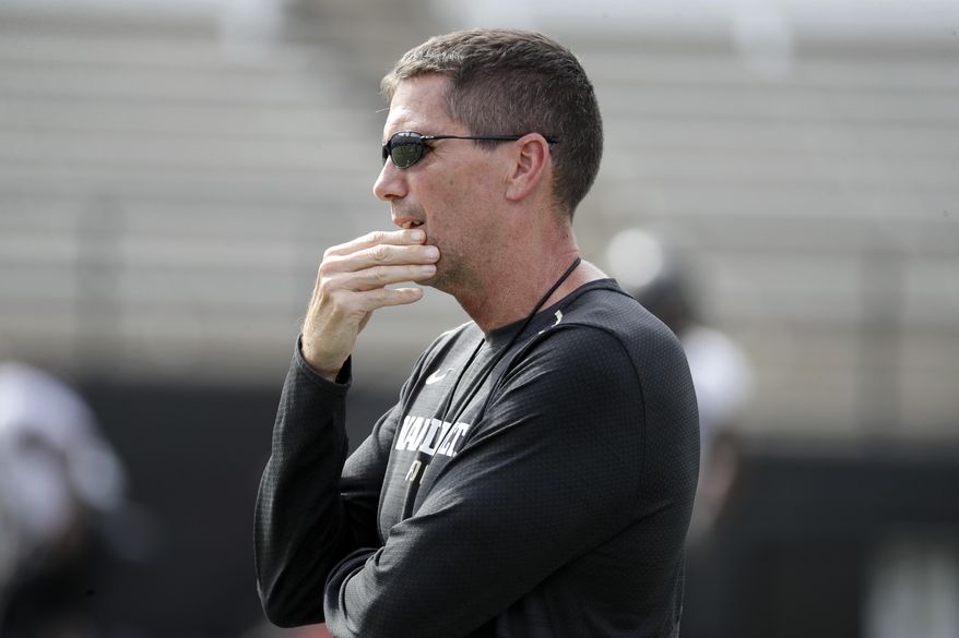 FILE - In this Aug. 16, 2018, file photo, then-Vanderbilt offensive coordinator Andy Ludwig watches during an NCAA college football practice in Nashville, Tenn. Ludwig is back as offensive coordinator at Utah with an evolving playbook. Utah's players are embracing Ludwig's offense with enthusiasm. It is a bit slower and features more huddles between plays than what they've run in the past. Still, they are seeing and absorbing aspects of the game in a whole new way.(AP Photo/Mark Humphrey, File)