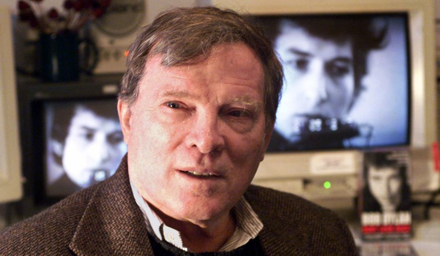 CORRECTS TO FIRST NAME TO FRAZER INSTEAD OF FRANK PENNEBAKER  FILE - In this Jan. 27, 2000 file photo, documentary filmmaker D.A. Pennebaker is flanked by 35-year-old images of Bob Dylan as Pennebaker sits in his New York editing suite. Oscar-winning documentary maker Pennebaker has died at the age of 94. Frazer Pennebaker said in an email his father died Thursday, Aug. 1, 2019, at his Long Island home from natural causes. (AP Photo/Kathy Willens, File)